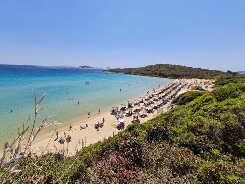 a group of people on a beach with the ocean at Niriis Studios Aktaia & Glauke Batsi in Batsi
