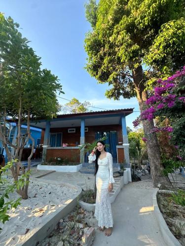 a woman is standing in front of a house at Garden Bungalows Koh Rong in Koh Rong