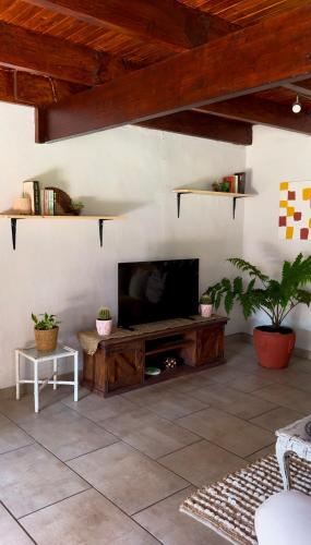 a living room with a television on a table at Casa De La Luna in Winterton