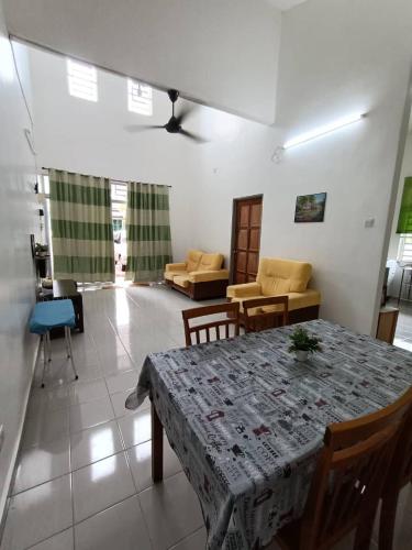 a living room with a table and a couch at MJ Homestay Bintong in Kangar