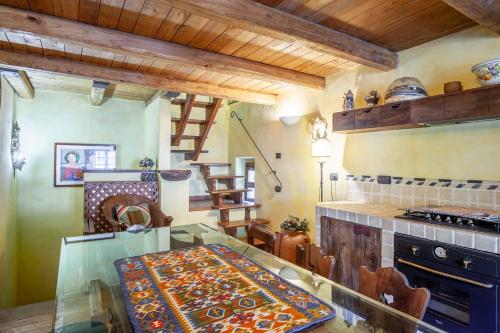 a kitchen with a glass table and a stove at Il guardiano del Castello in Fivizzano