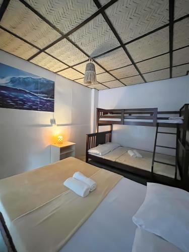 a bedroom with two bunk beds and a lamp at LaZerena Lodge in Zambales