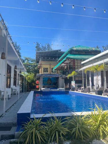a swimming pool with a water slide in a building at LaZerena Lodge in Zambales