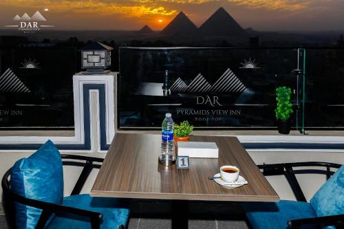 a table with a cup of coffee on a balcony at DAR Pyramids View Inn - Rooftop in Cairo