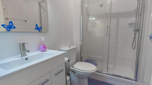 a bathroom with a shower and a toilet and a sink at Bravo Hills - Casa Jean in Ciudad Quesada