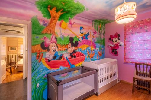 a childs room with a disney mural at Τraditional fully detached villa on a luxurious hillock of Thessaloniki with its own garden also for family & wedding gatherings for 10 to 25 people only 15 minutes from airport in Thessaloniki