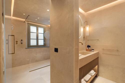 a large bathroom with a sink and a shower at Villa Petriolo - Small Luxury Hotels of the World in Cerreto Guidi