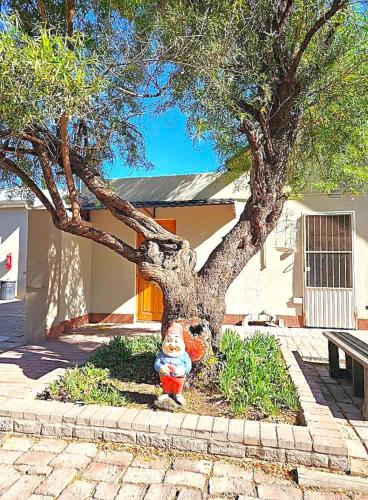 a fire hydrant sitting in front of a tree at Donkin Country House in Beaufort West