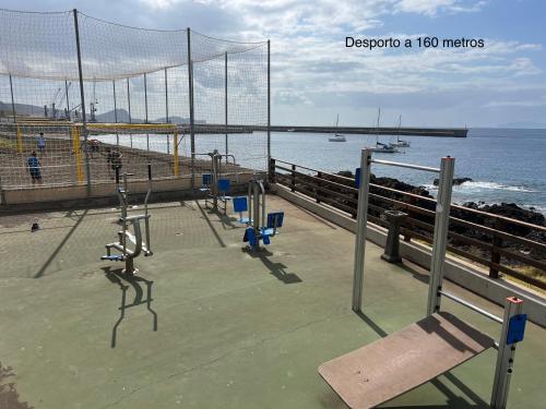 a volleyball net on a pier next to the ocean at Caniçal houses - Madeira in Caniçal