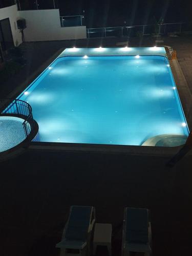 a large swimming pool with lights on top of it at A dream house with a dream view in ROYAL PARK in Alanya