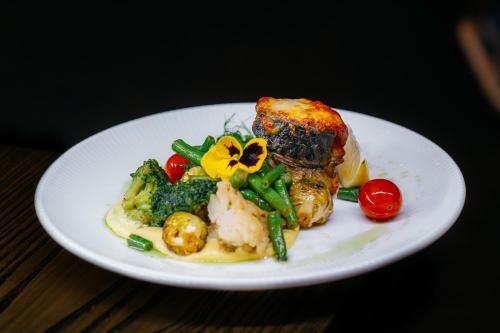 a plate of food with meat and vegetables on a table at Rado Hotel Spa in Khmil'nyk