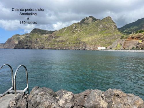 a view of a body of water with mountains at Caniçal houses - Madeira in Caniçal