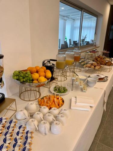 a buffet with fruits and vegetables and glasses of orange juice at Relais San Giorgio in Pignataro Maggiore