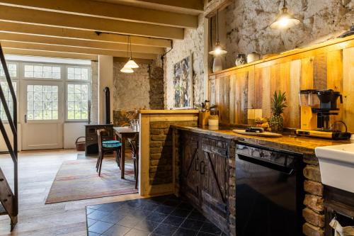 a kitchen with wooden cabinets and a counter top at Gut Neuwerk in Kall