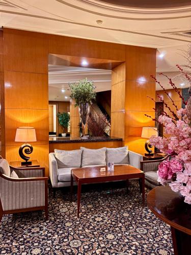 a living room with a couch and a table at Manado Quality Hotel in Manado
