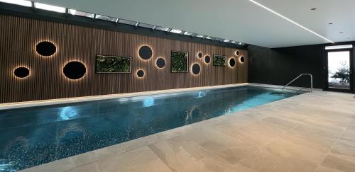 a swimming pool in a room with a wall at La Clef des Champs in Morzine