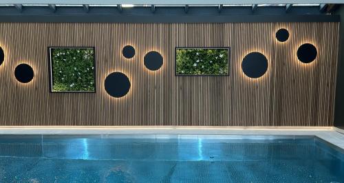 a wall with three windows and a swimming pool at La Clef des Champs in Morzine