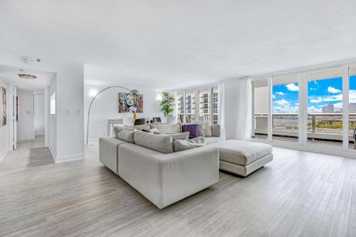 a white living room with a couch and a table at The Grand Biscayne Bay in Miami