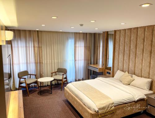 a hotel room with a bed and a table and chairs at Sabiha Sultan Hotel-Karakoy in Istanbul