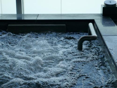 a pool of water with a water hose at asbo stay hotel in Kin