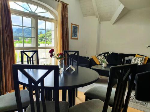 a living room with a table and chairs and a couch at Villa Rose in Sankt Kanzian