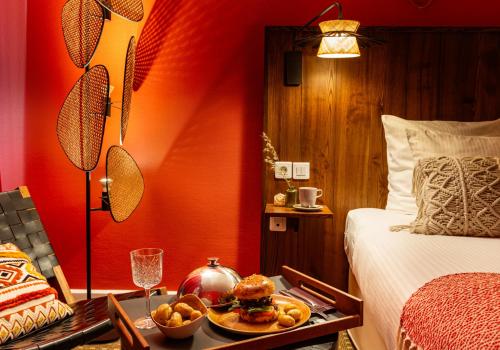 a hotel room with a tray of food on a table at Aiden by Best Western Paris Roissy CDG in Roissy-en-France
