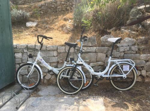 two bikes parked next to a stone wall at Apartments Agava & Lucija in Povlja