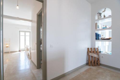 a hallway with a door leading to a living room at Piperi On The Rocks in Naousa