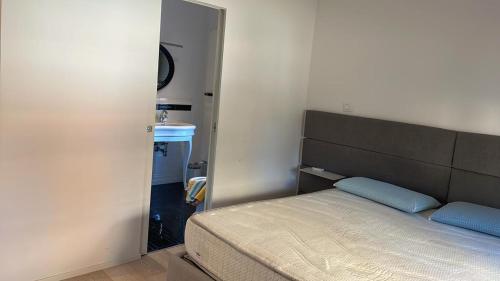 a small bedroom with a bed and a mirror at A DUE PASSI in Castel di Lama