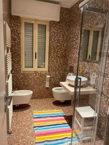 a bathroom with two sinks and two toilets at A DUE PASSI in Castel di Lama