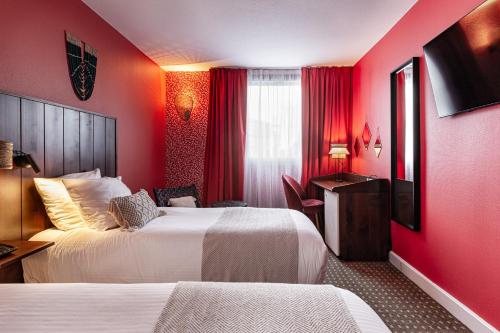 a hotel room with two beds and red walls at Aiden by Best Western Paris Roissy CDG in Roissy-en-France