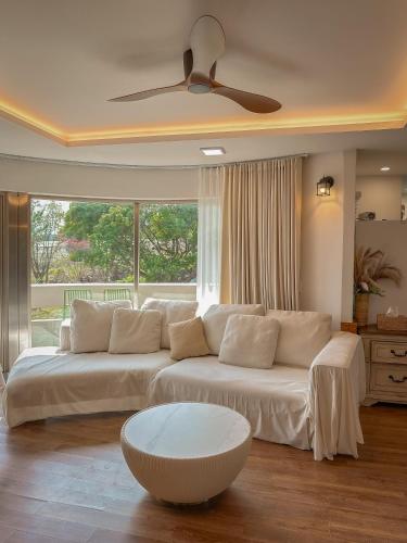 a living room with a couch and a ceiling fan at Seogwipo Classic in Seogwipo