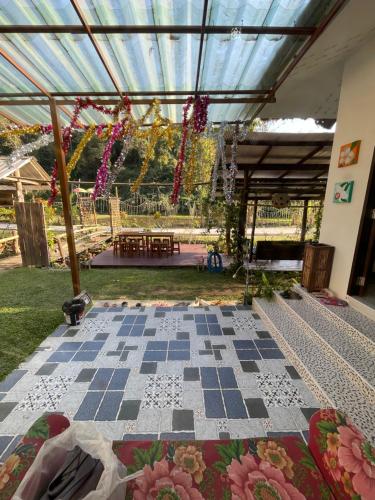 a patio with a checkered floor and a glass ceiling at Napa White Villa river front in Ban Pang Mung