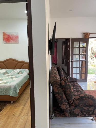 a room with a bed and a chair in a room at Napa White Villa river front in Ban Pang Mung