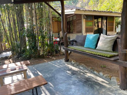 a porch with a bench in front of a house at Napa White Villa river front in Ban Pang Mung