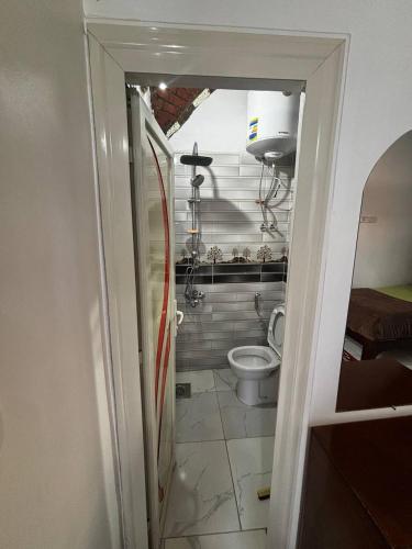 a small bathroom with a toilet in a room at Nile View Guest House in Aswan