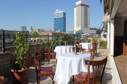a balcony of a restaurant with tables and chairs at OTEL KÂYA in Izmir