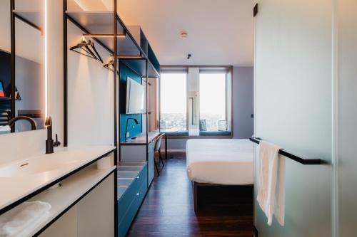 a bedroom with a bed and a sink and a mirror at A-STAY Antwerp in Antwerp