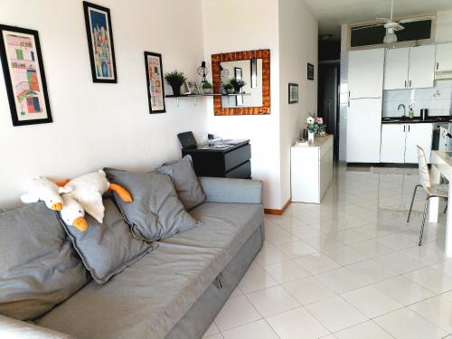 a living room with a couch with a stuffed animal on it at Bellavista apartment Letojanni in Letojanni