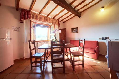 a kitchen and dining room with a table and chairs at Agriturismo Palazzo Bandino - Wine cellar, on reservation restaurant and spa in Chianciano Terme