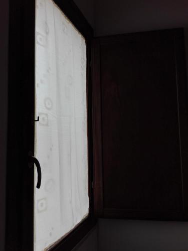 a window in a room with white curtains at Segesta Antichi Sapori in Calatafimi