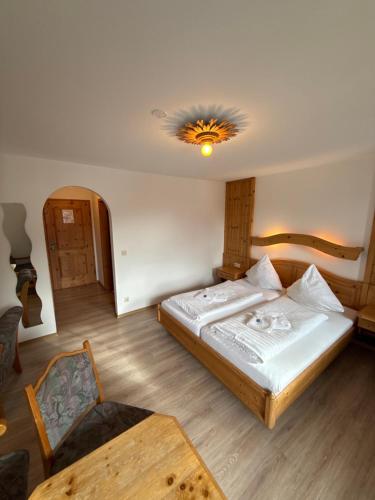 a bedroom with a bed and a table in it at Gasthof Und Hotel Maria Gern in Berchtesgaden
