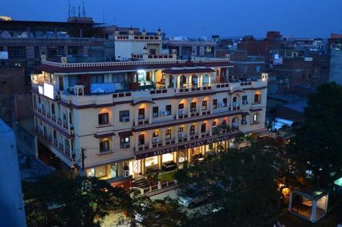 a large white building with lights on it at night at Hotel Vijay Niwas in Jaipur