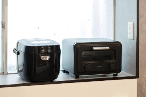 a toaster and a printer sitting on a shelf at WONDERDREAM STAY NEW KASHIWA with Free parking in Kashiwa