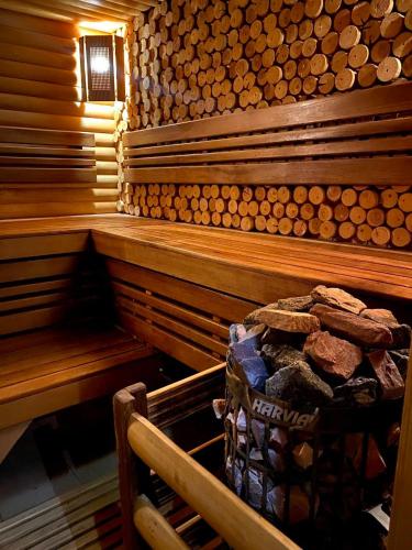 a wooden sauna with a pile of logs in it at Boutique Hotel California in Odesa