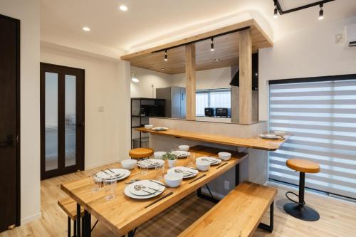 a dining room with a wooden table and chairs at WONDERDREAM STAY NEW KASHIWA with Free parking in Kashiwa