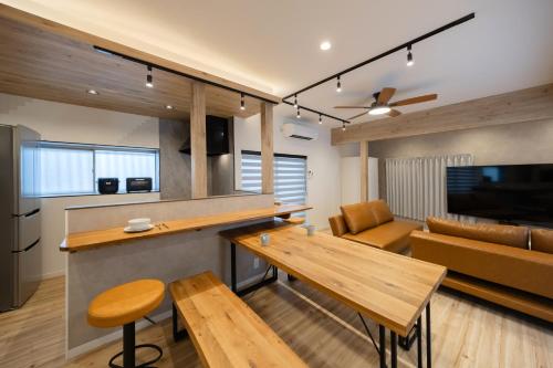 a kitchen and living room with a table and a couch at WONDERDREAM STAY NEW KASHIWA with Free parking in Kashiwa