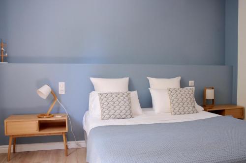 a bedroom with a bed with white sheets and pillows at Domaine de Selhac in Frontignan