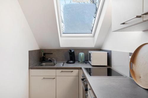 a kitchen with a sink and a window at Ferienhaus Landliebe in Ötisheim