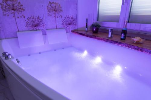 a white bath tub with lights in a bathroom at BeB Domus Arbenzio San Giovanni Suite in Rome